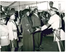 Death of Kenyatta (1978)_Kenya army officer presents Mzee Jomo Kenyatta presidential standard and the national flag to Mama Ngina Kenyatta while President Moi looks on during funeral mass_31.8.1978