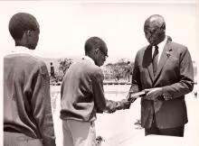 President Daniel Arap Moi Presents a Bible to one of the students of Moi High School Kabarak during the baptismal worship led by Rev Johnes Kareri